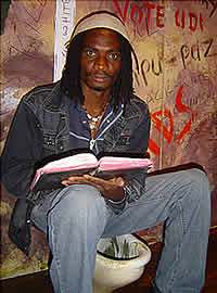 Owen Maseko reading the bible in the toilet