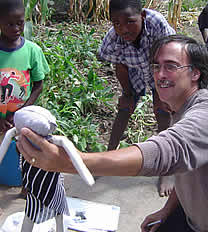 Dennis Gaboury admires a doll that has been made by one of the orphans for the competition