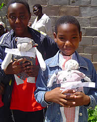 Take a look at our dolls! Girls show off their hand-made dolls.