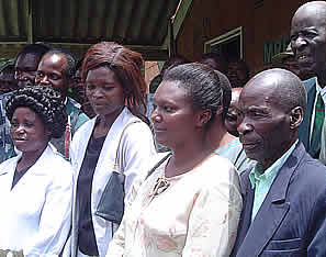 Murehwa community looks at the Swedish Ambassador cutting ribbons on the motorvehicle.