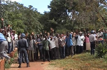Riot police keep supporters and members of the public away from the court