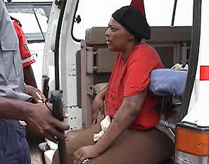 Grace Kwinjeh sits in an ambulence outside the Rotten Row Magistrates Court waiting to be carried to hospital