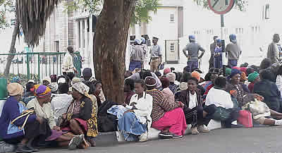 Members of the Women of Zimbabwe Arise and Men of Zimbabwe Arise surrounded by riot police outside the Parliament building in Harare 