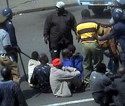 Riot police force the ZCTU leaders to sit on the ground