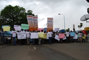 Demonstrators carry placards