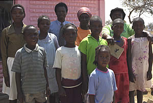 Pastor Sikiani and his wife pose for a photograph with some of the children they are looking after