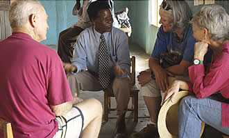 Pastor Sikiani in discussion with volunteers who include Caroline Lapham (extreme right)