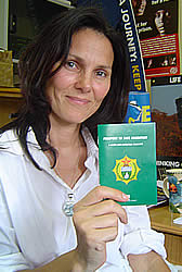 Nicola Simmons holding the Passport to Safe Migration