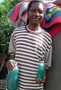 Bigboy Bingura holds the liquid soap he has manufatured for selling