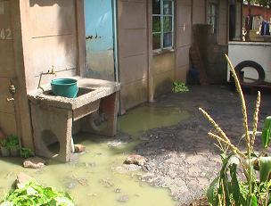 Human excrement is flowing out of the residents' toilets and into their back yards