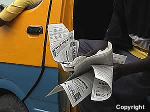 Commuter omnibus conductor distributing WOZA information