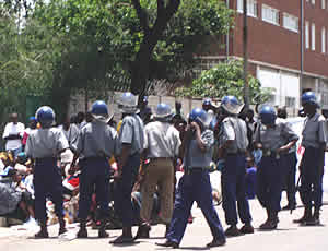 Riot police round up members of WOZA & MOZA during a peaceful launch of the People's Charter in Bulawayo. © WOZA