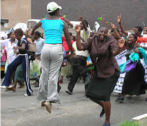 Jumping for joy! WOZA members marching in Harare with red roses in hand